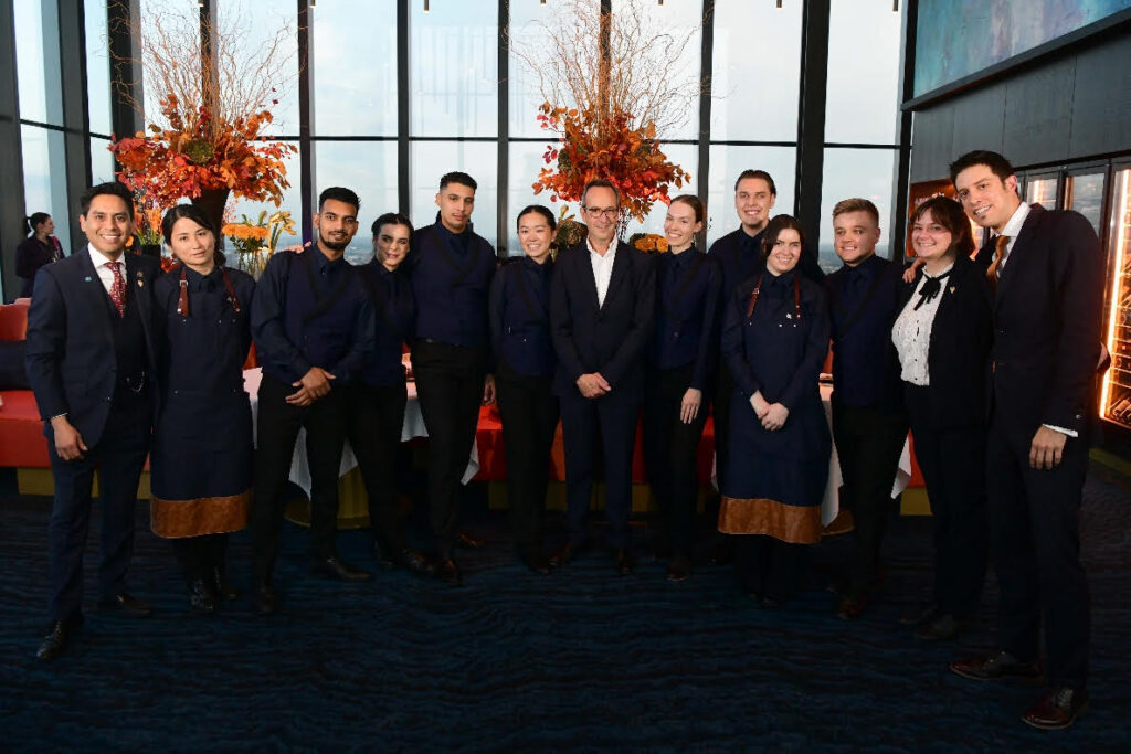 IMAGE TEXT: Orelle restaurant team with CEO of D&D, David Loewi (central to image)
